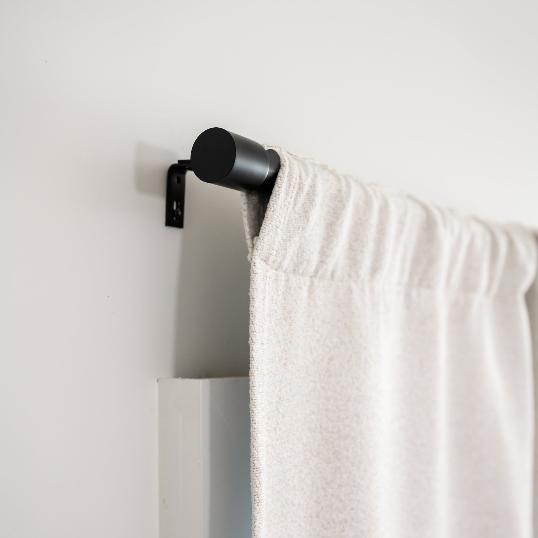 Side view of Brooklyn Boucle curtain in rod pocket style on the Rockford Rod, showing the clean, modern finish.