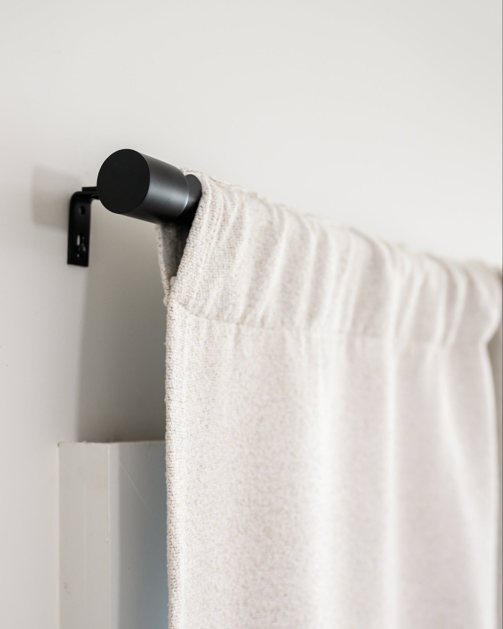 Side view of Brooklyn Boucle curtain in rod pocket style on the Rockford Rod, showing the clean, modern finish.