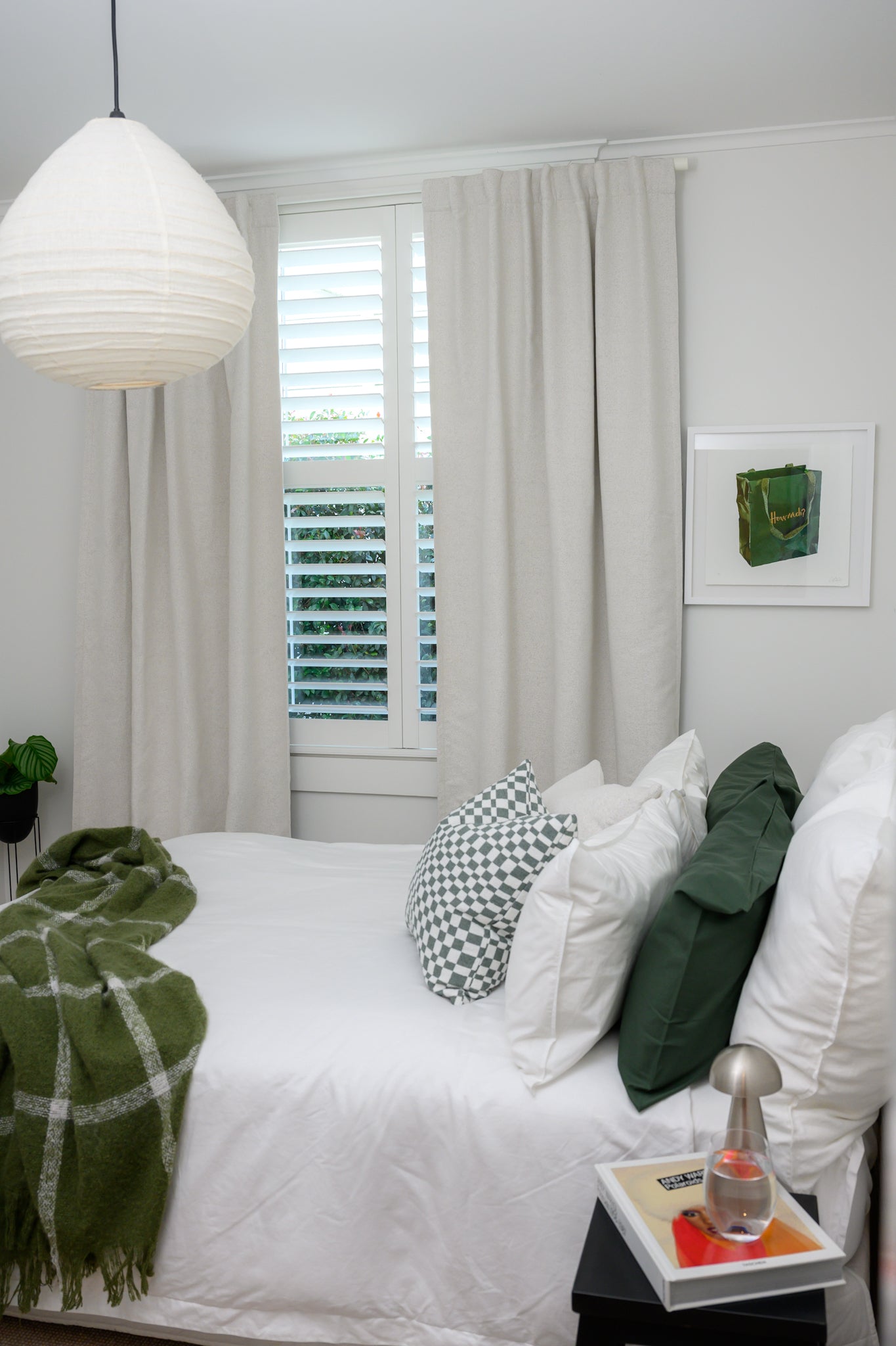 Brooklyn Boucle curtain styled in a bedroom with sage accents, featuring Chicago Check cushion in Sage and Brooklyn Boucle cushions for a cool, modern look.