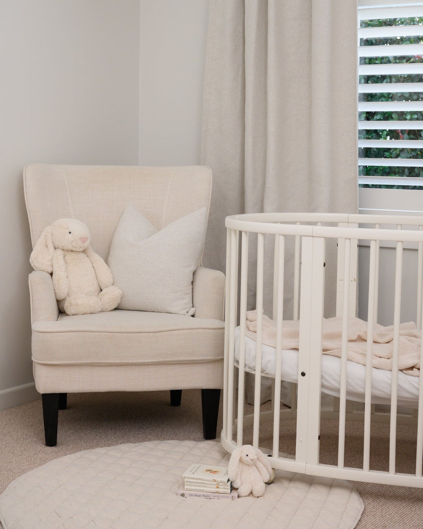 Brooklyn Boucle curtains with matching boucle cushion — the ideal choice for a baby nursery, adding softness, warmth, and room darkening.