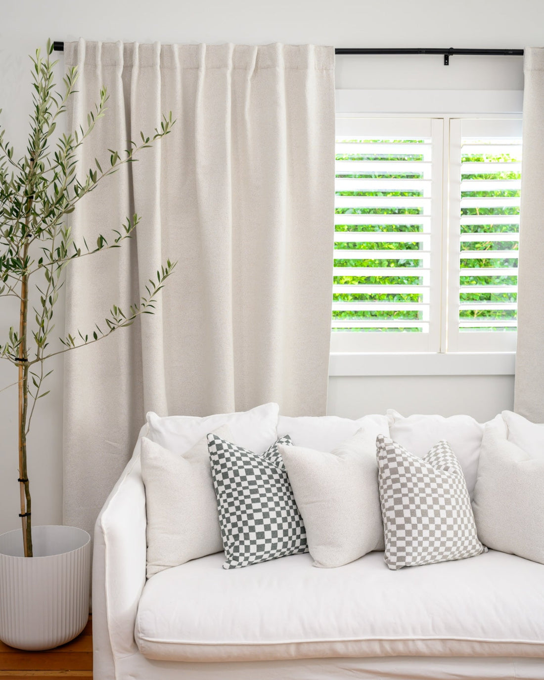Brooklyn bouclé curtains with white couch and Chicago Check cushions for a modern, textured living room look.