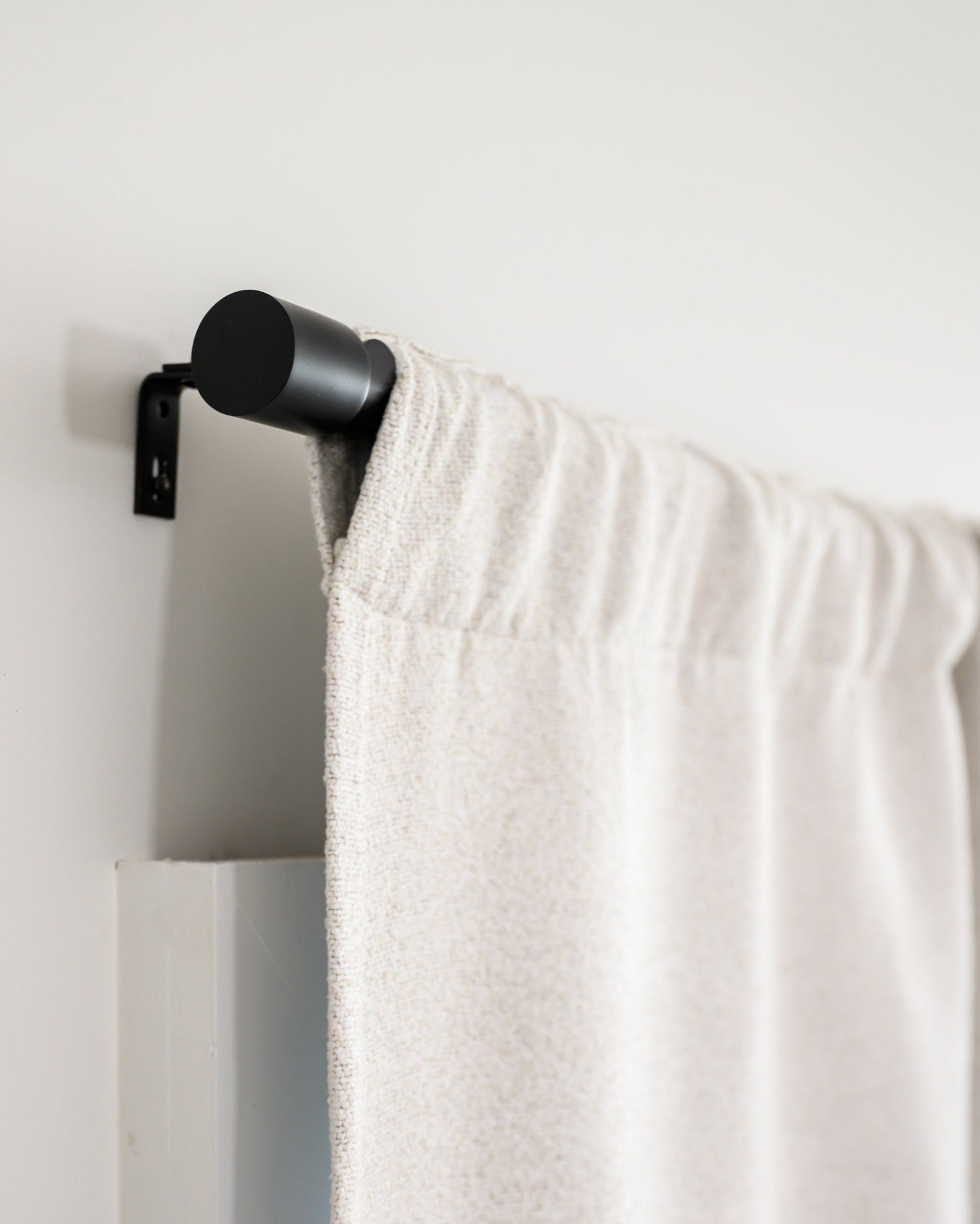 Side view of Brooklyn Boucle curtain in rod pocket style on the Rockford Rod, showing the clean, modern finish.