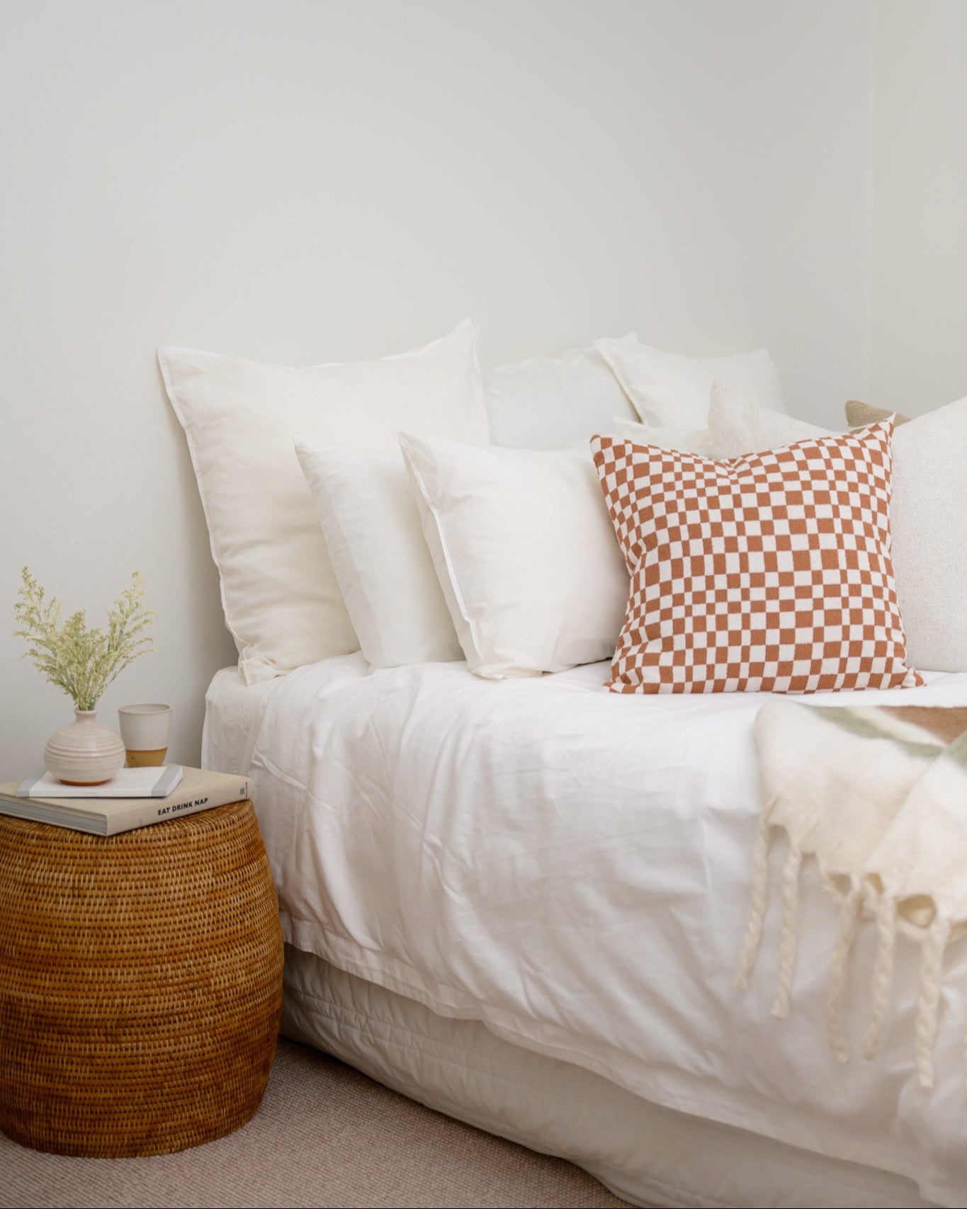 Bedroom styled with Chicago Check cushion in Terracotta and Brooklyn Boucle cushions, creating a warm, coordinated finish with layered textures.