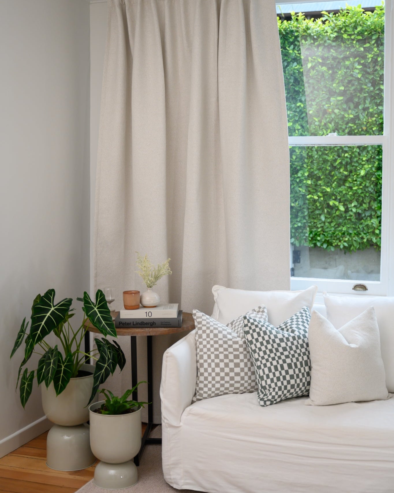 Chicago Check cushions in Sage and Dove Grey styled in a lounge with Brooklyn Boucle curtain for a cohesive designer look.