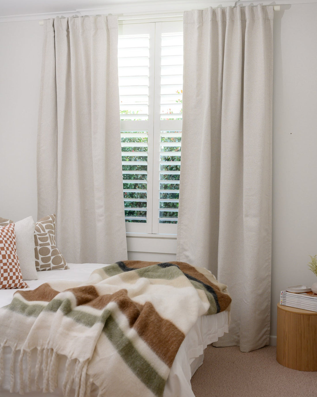 Neutral bedroom with warm accents styled with Brooklyn Boucle curtain, adding texture, warmth, and a cosy, inviting feel.