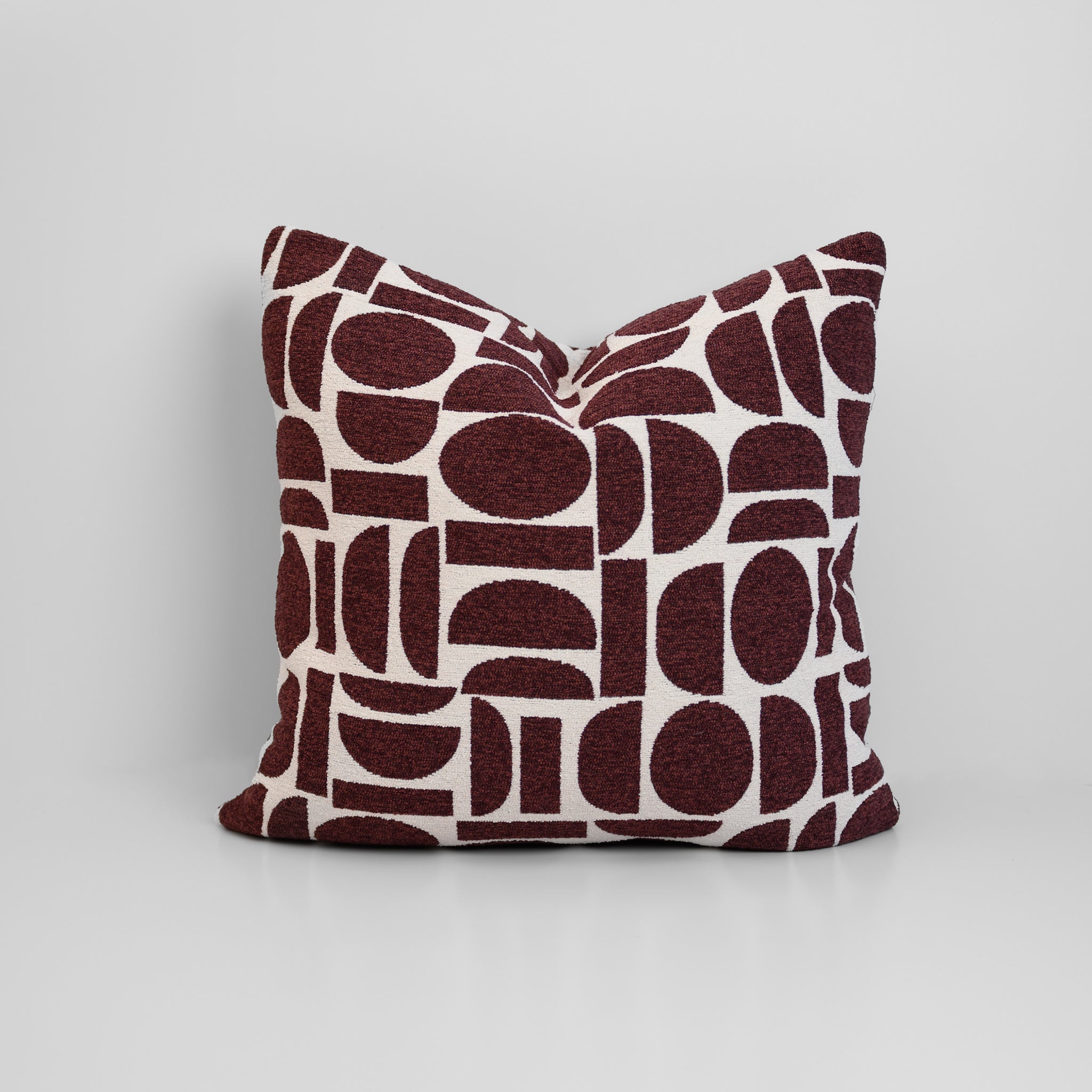 Chelsea Crescent Cushion in Burgundy with boucle texture and geometric design, styled for a chic, modern finish.