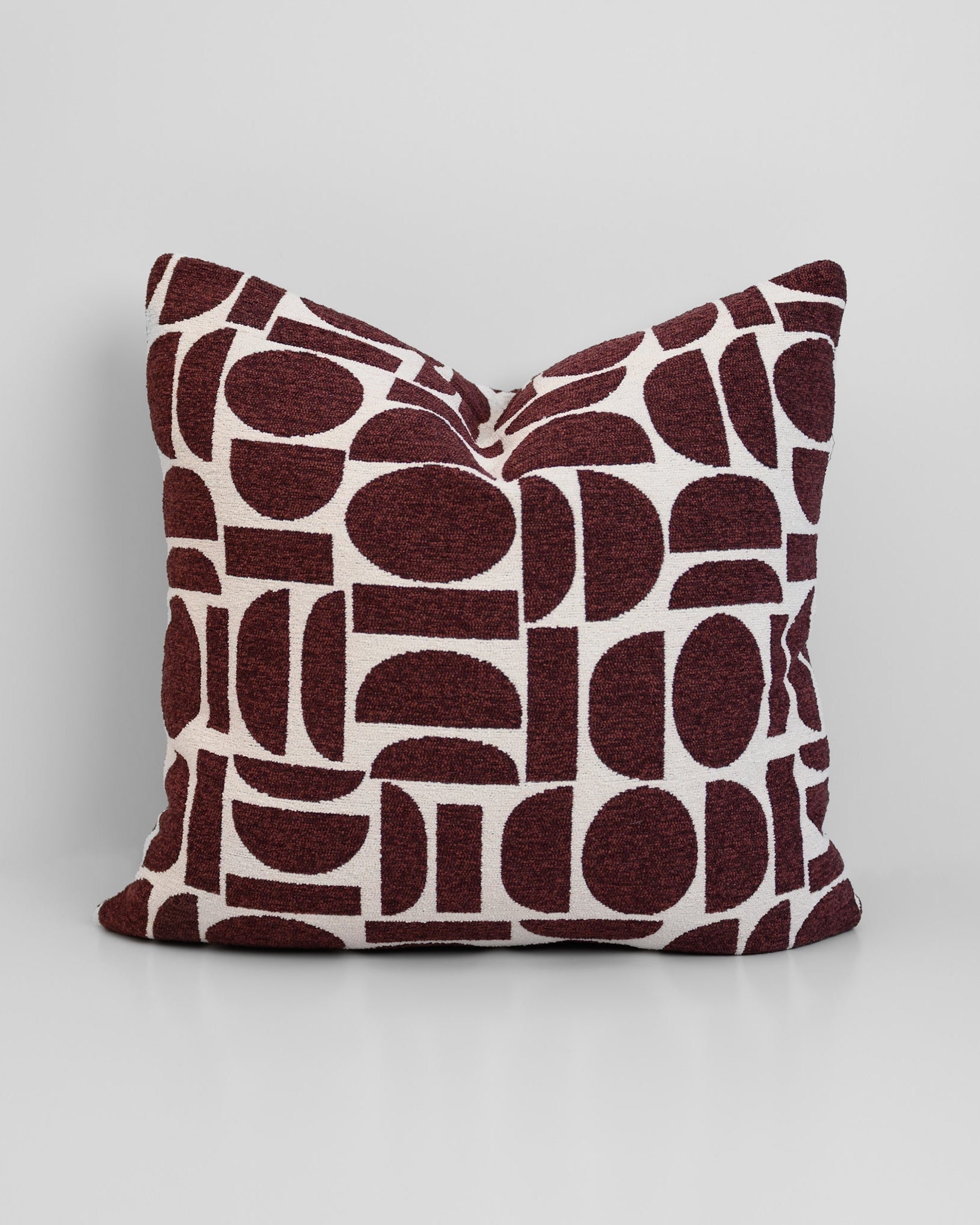 Chelsea Crescent Cushion in Burgundy with boucle texture and geometric design, styled for a chic, modern finish.