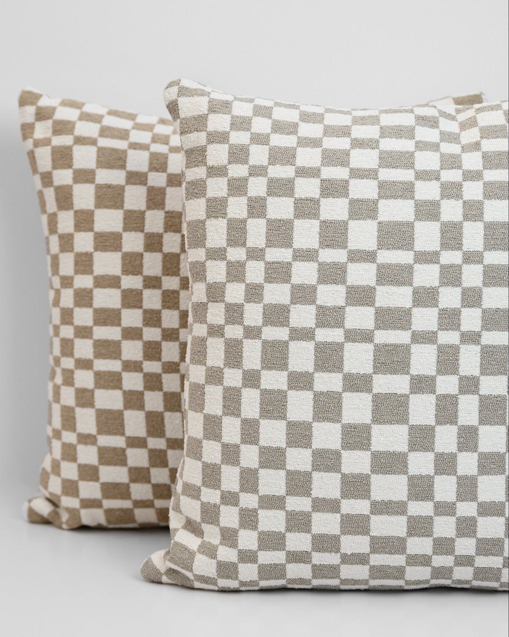 Chicago Check Cushions stacked in Dove Grey and Taupe with boucle texture and tonal check pattern for a modern, layered look.