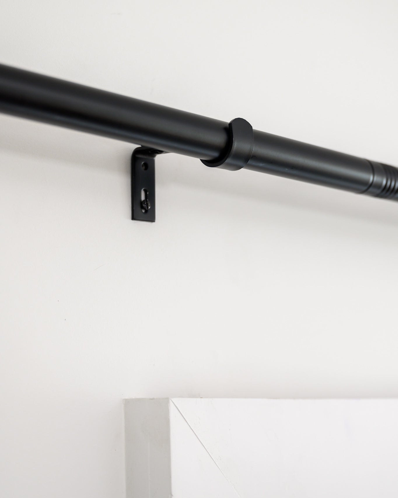 Close-up of Rockford Rod in black, showing the sturdy wall brackets and sleek designer hardware.