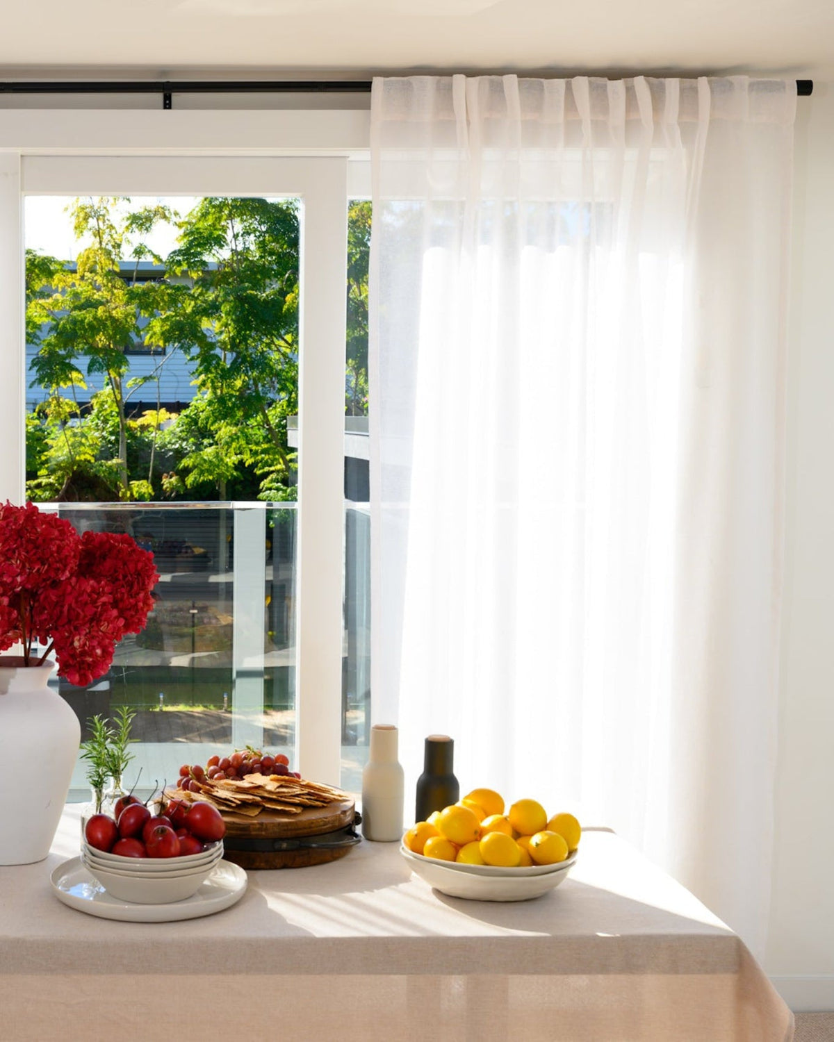 The Soho Sheer Soft White syled in the dining room to add a layer of texture and to softly filter light.