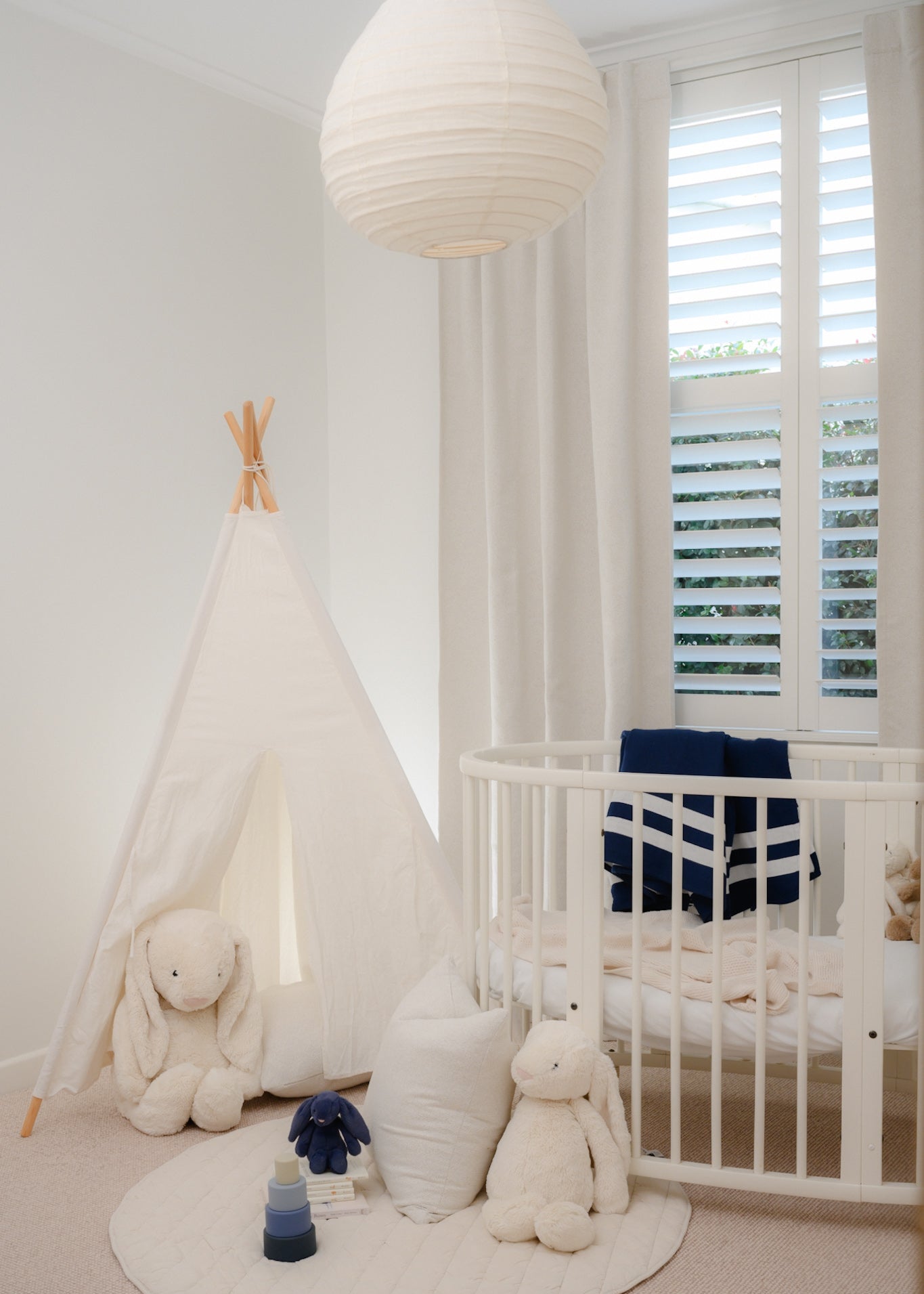 White bouclé curtain styled in a baby boy’s nursery, offering room-darkening and insulation benefits — soft, textured, and ideal for cosy spaces.