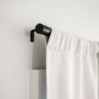 Side view of Brooklyn Boucle curtain in rod pocket style on the Rockford Rod, showing the clean, modern finish.