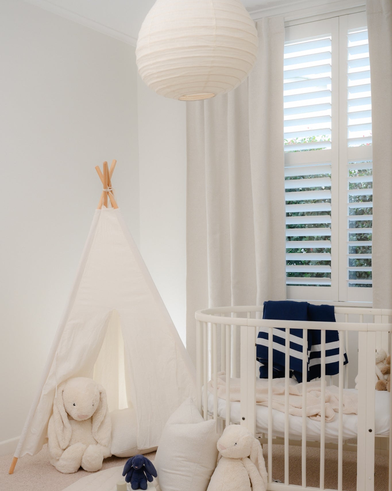 Boys’ nursery in soft natural tones with a navy accent, styled with Brooklyn Boucle Lined Curtains, white crib, and cosy neutral decor.