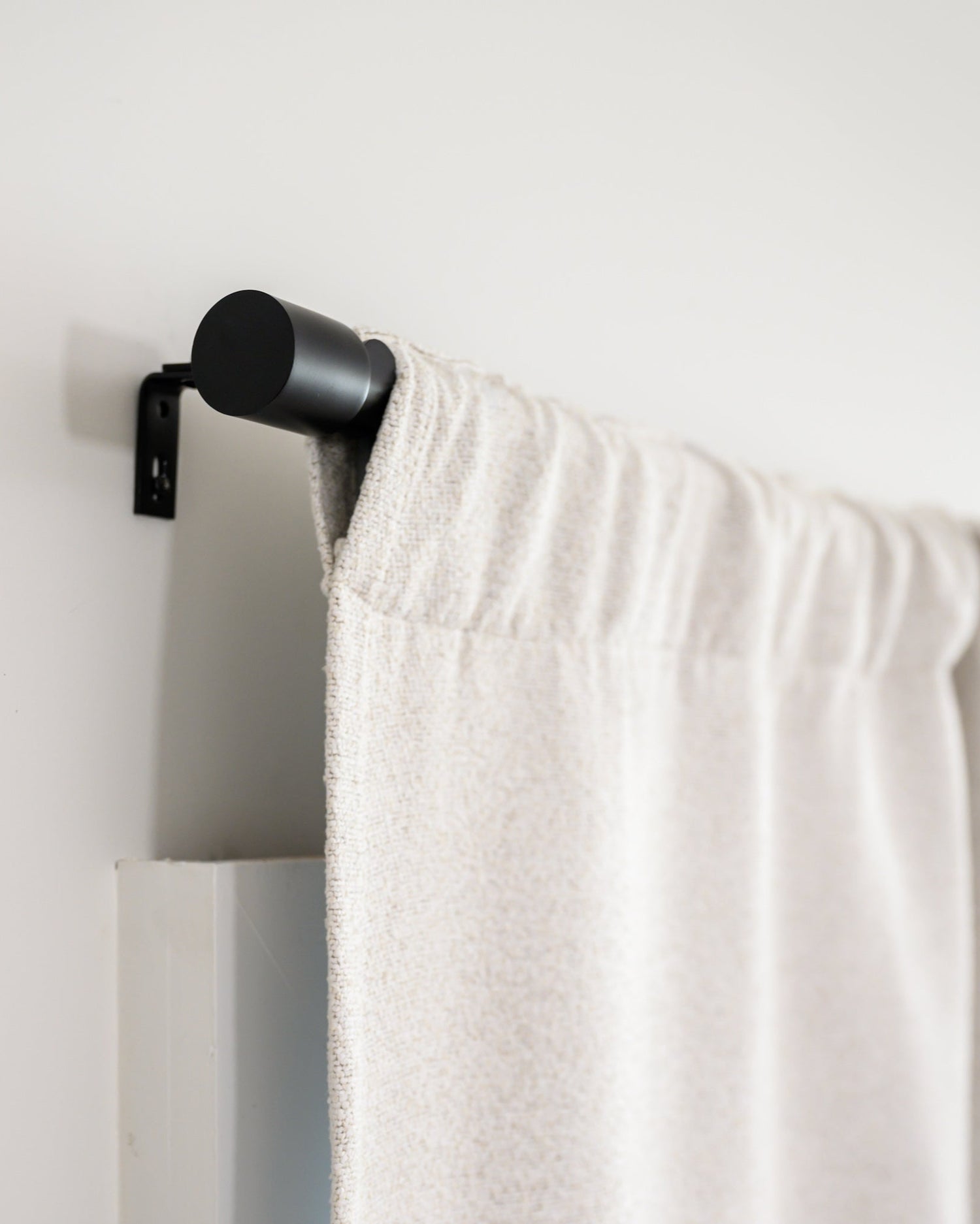 Side view of Brooklyn Boucle curtain in rod pocket style on the Rockford Rod, showing the clean, modern finish.