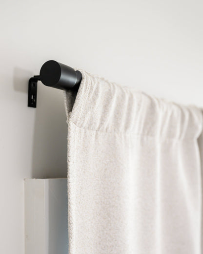Side view of Brooklyn Boucle curtain in rod pocket style on the Rockford Rod, showing the clean, modern finish.
