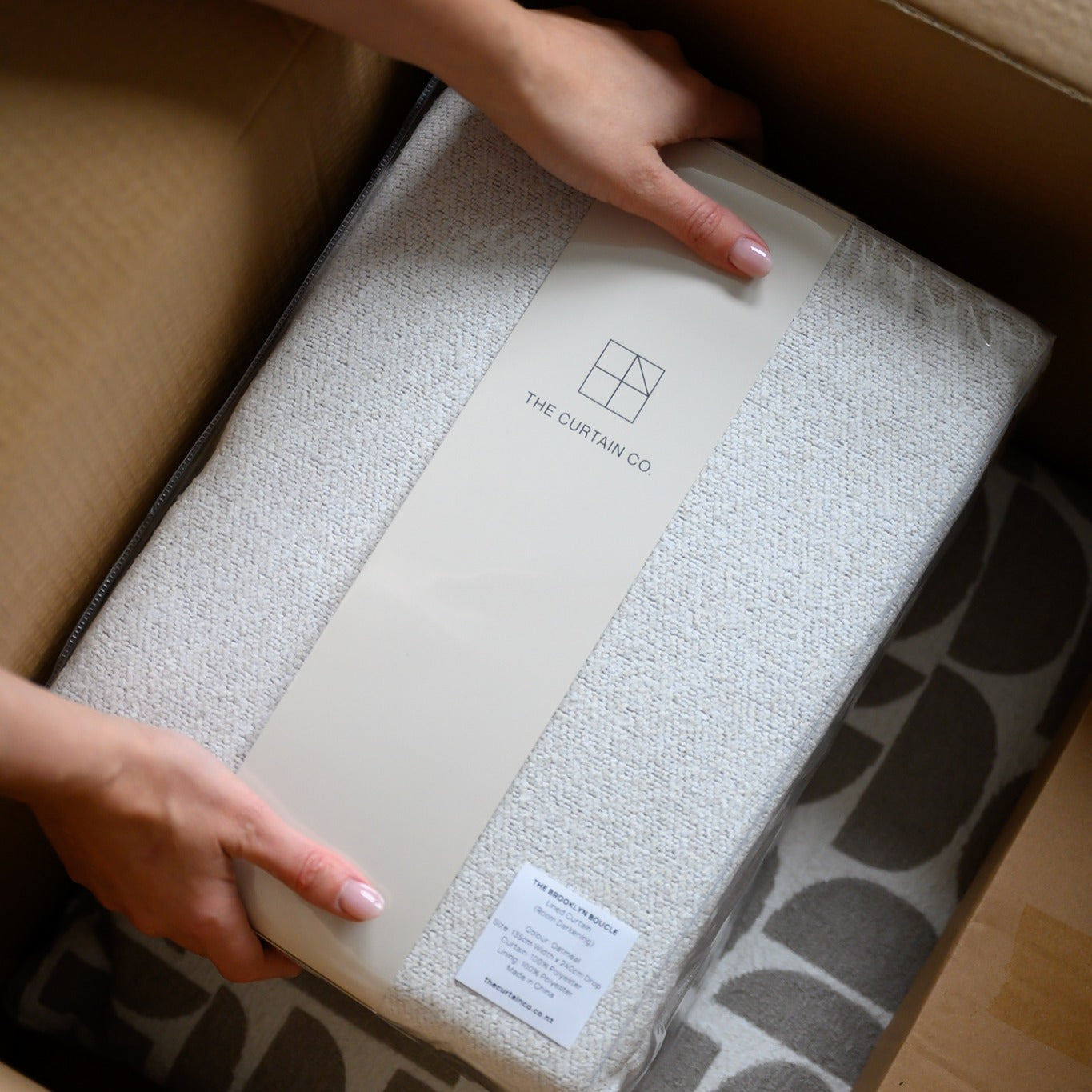 Customer unpacking a Curtain Co order at home, showing fast, easy delivery and beautifully packaged curtains.