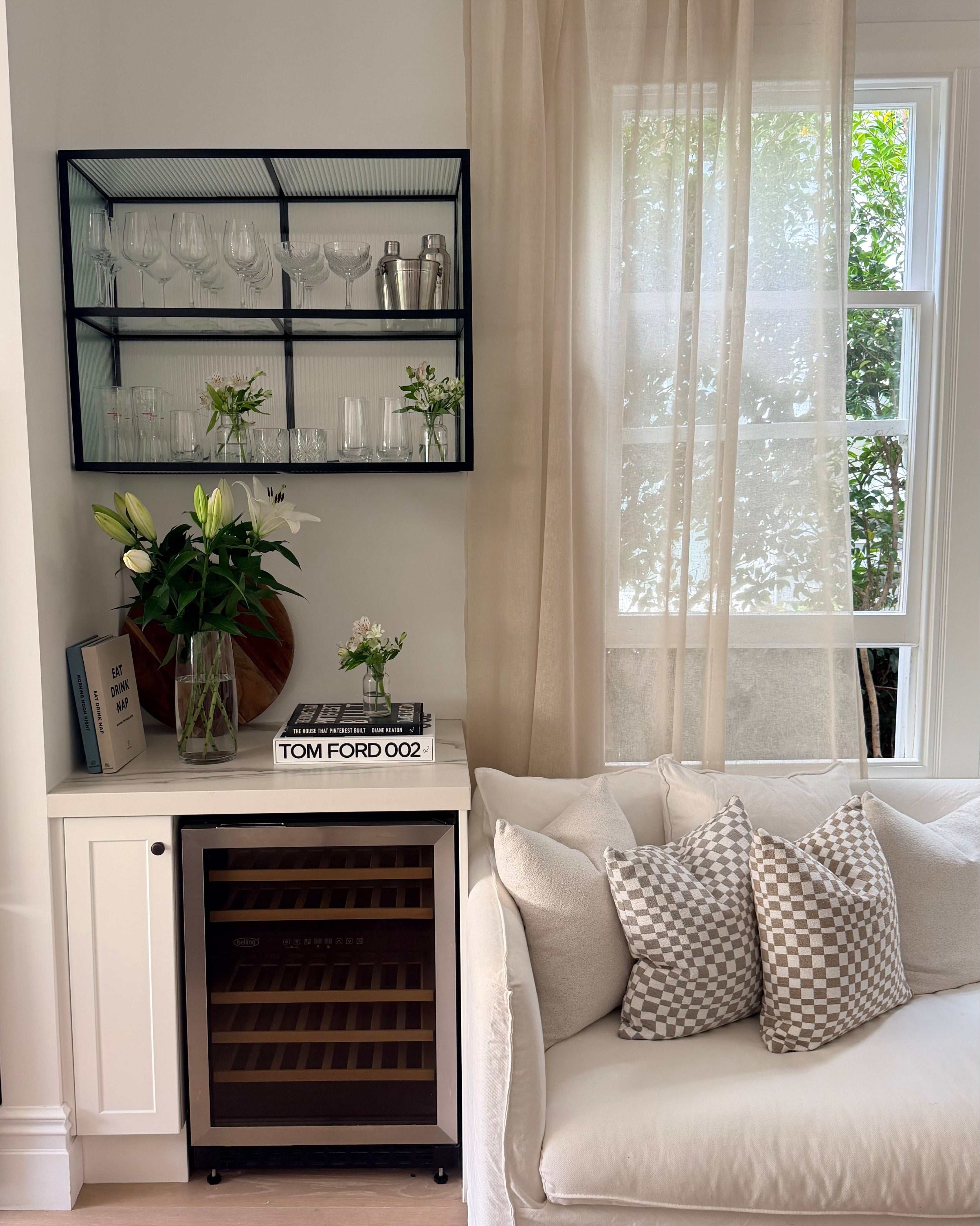 Soho Sheer curtain in Natural linen blend, softly filtering light in a modern lounge with neutral furnishings.