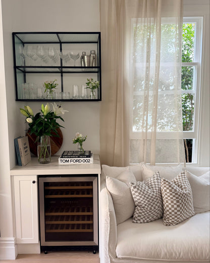 Soho Sheer curtain in Natural linen blend, softly filtering light in a modern lounge with neutral furnishings.