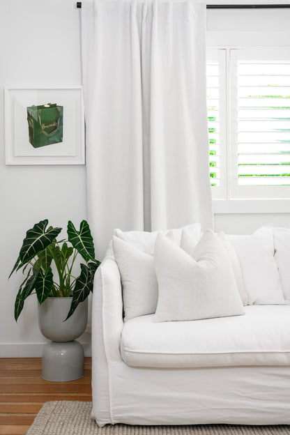 Brooklyn Boucle cushions with plump feather and down inners styled on a modern white couch — the perfect finishing touch for a designer look.