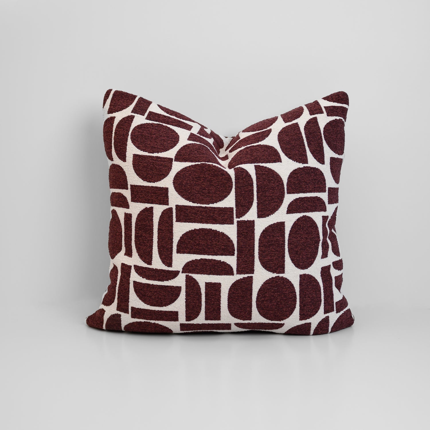 Chelsea Crescent Cushion in Burgundy with boucle texture and geometric design, styled for a chic, modern finish.