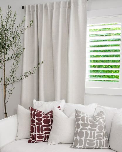 Chelsea Crescent cushions in burgundy and dove grey styled with a Brooklyn Boucle cushion, creating a cohesive designer look.
