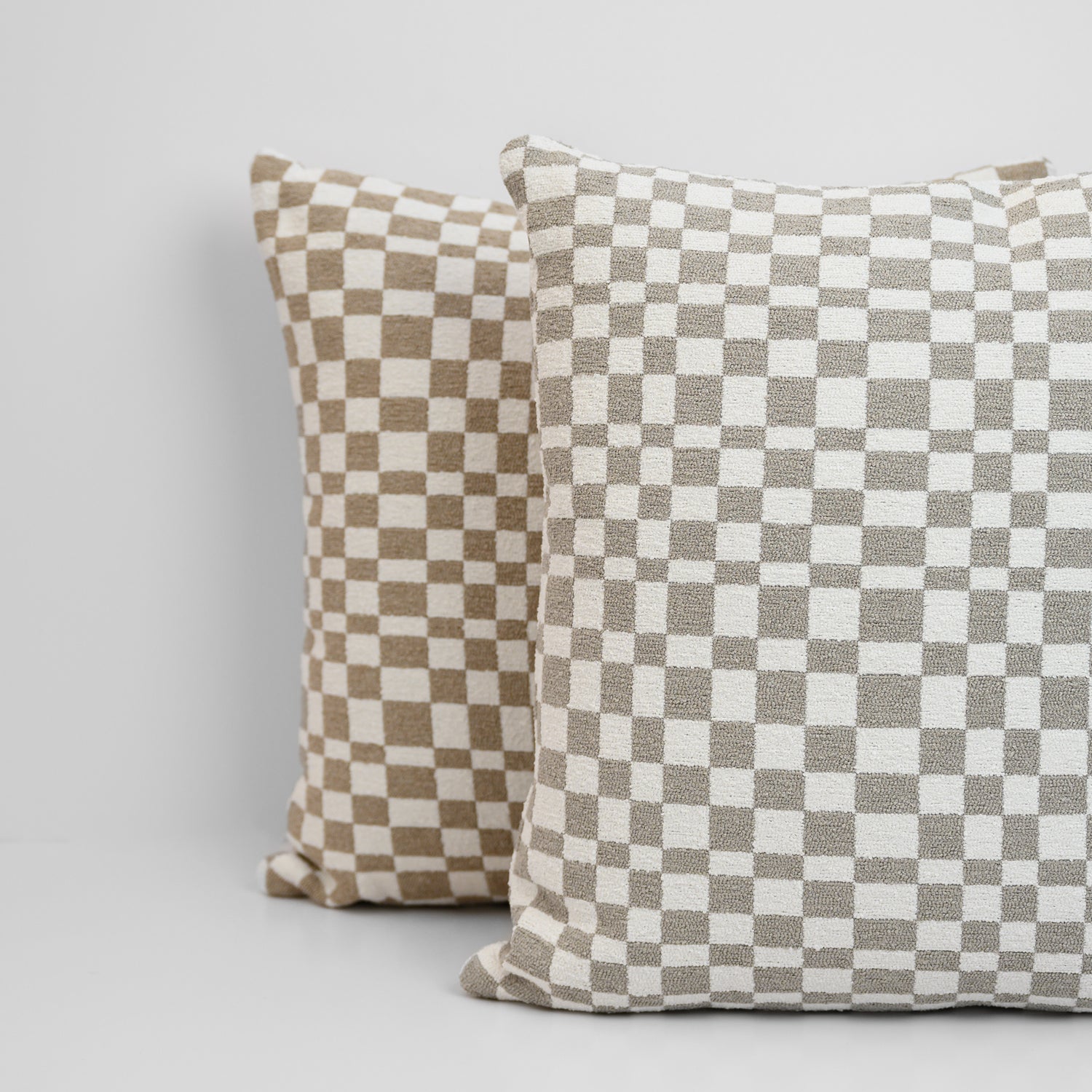 Chicago Check Cushions stacked in Dove Grey and Taupe with boucle texture and tonal check pattern for a modern, layered look.