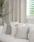 Chicago Check cushions in sage and dove grey styled with Brooklyn Boucle cushions, creating a cohesive designer look.