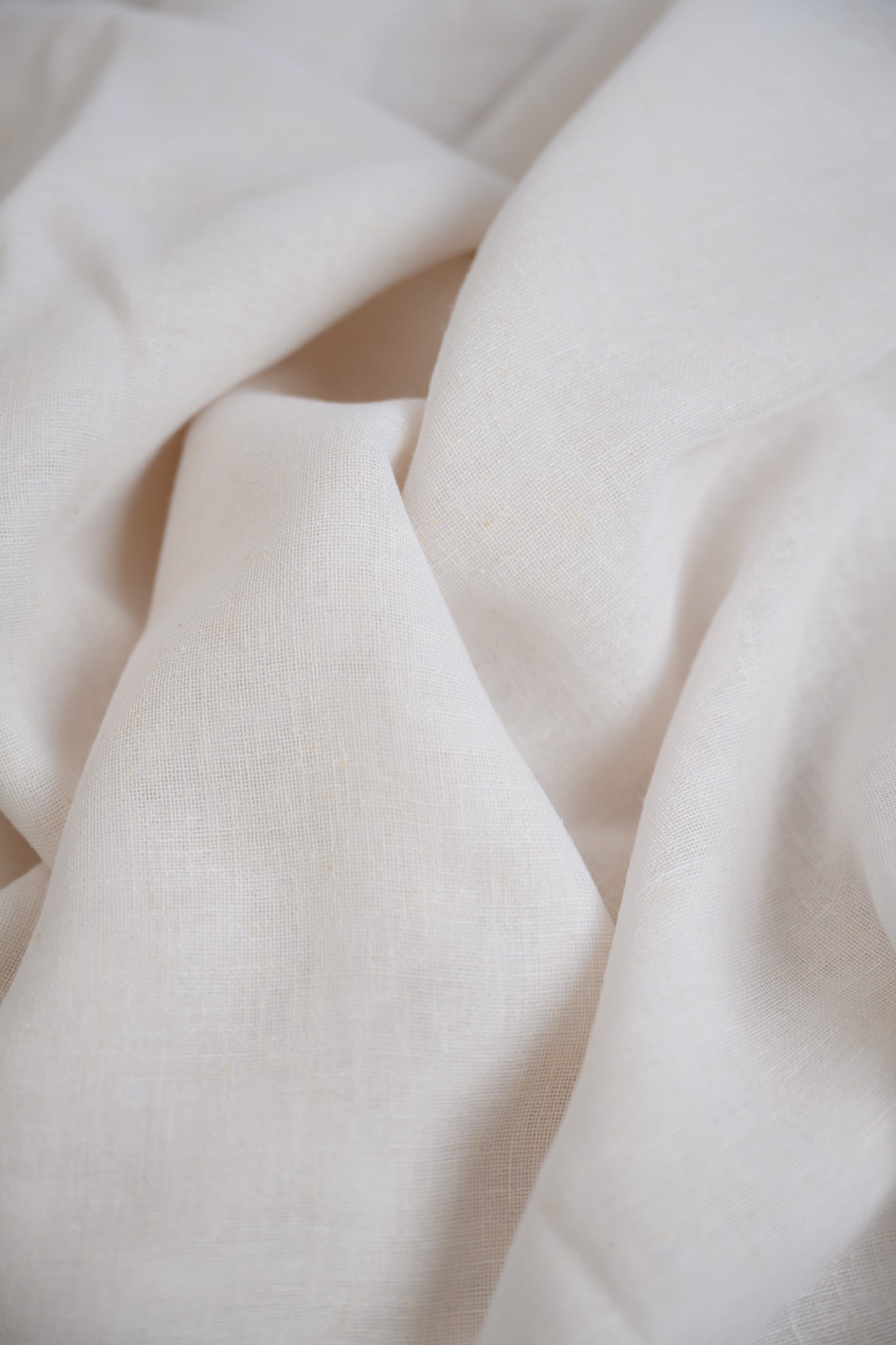 Close-up of Soho Linen fabric in Soft White, showing the beautiful texture and natural linen fibres for a soft, elegant finish.