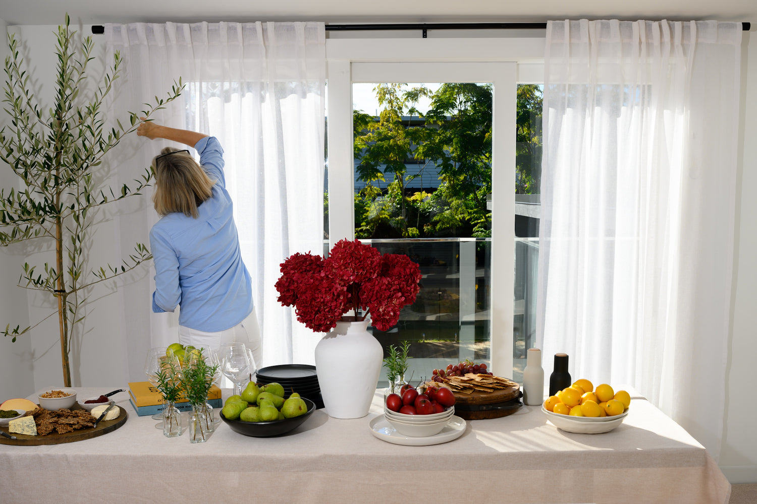 The Soho Sheer curtains styled in a dining room with a chic, modern table setting — the perfect backdrop for relaxed, stylish entertaining.