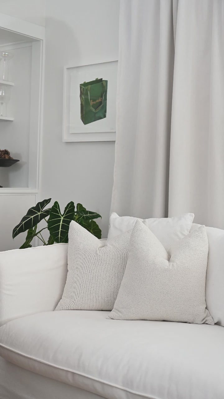 The Brooklyn Boucle cushion being styled with the perfect chop for a plump, designer finish.